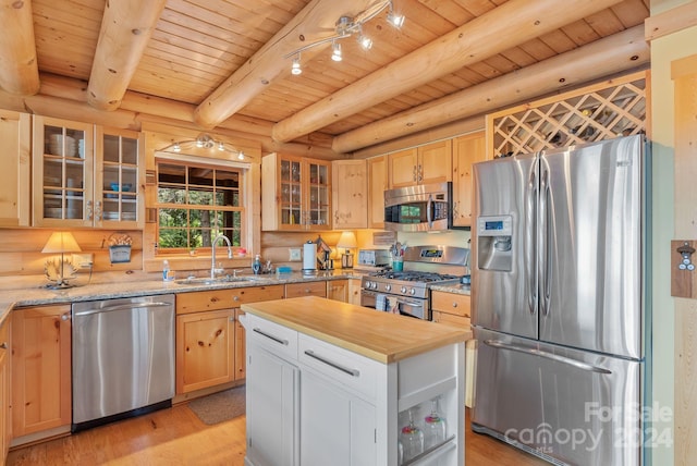 kitchen featuring log walls, light hardwood / wood-style flooring, stainless steel appliances, and beam ceiling