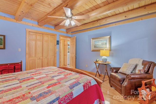 bedroom featuring wooden ceiling, a closet, beam ceiling, ceiling fan, and light wood-type flooring