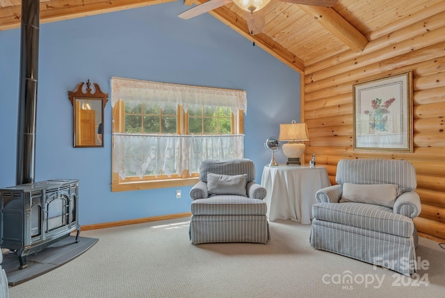 living area with beamed ceiling, a wood stove, rustic walls, wooden ceiling, and carpet floors