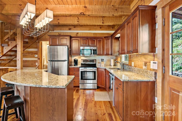 kitchen with wood ceiling, a healthy amount of sunlight, stainless steel appliances, and light hardwood / wood-style flooring