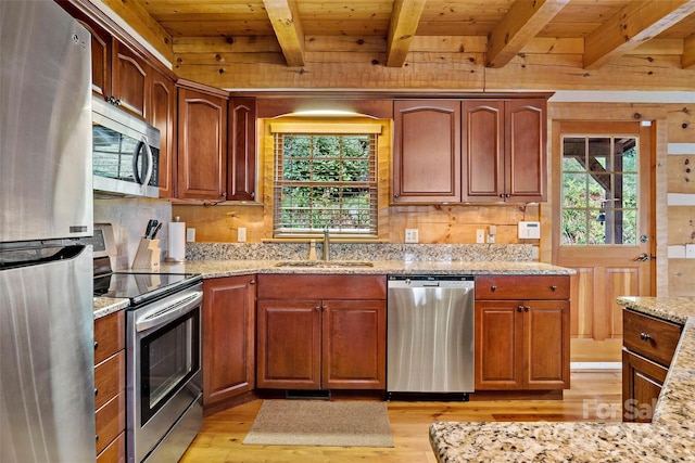 kitchen with wooden ceiling, light wood-type flooring, stainless steel appliances, and sink