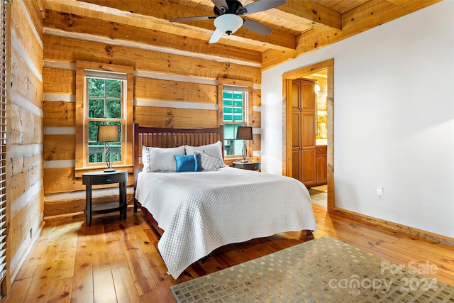 bedroom with wood walls, ceiling fan, hardwood / wood-style floors, and wooden ceiling