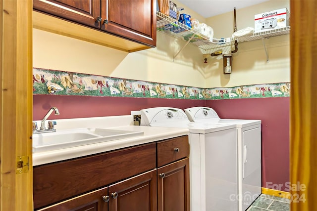 laundry room featuring cabinets, washer and clothes dryer, and sink