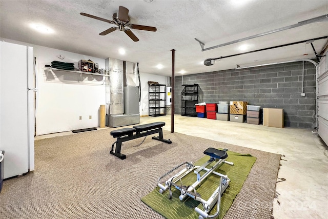 workout area featuring a textured ceiling and ceiling fan