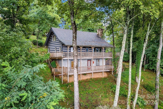 back of house featuring a wooden deck