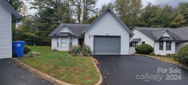 view of front of property featuring a front lawn and a garage