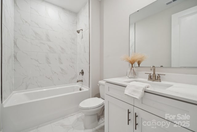 full bathroom with tiled shower / bath combo, toilet, and vanity