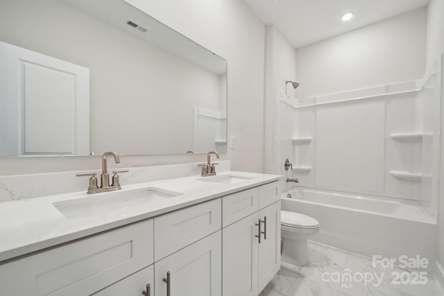 full bathroom featuring shower / bathing tub combination, vanity, and toilet