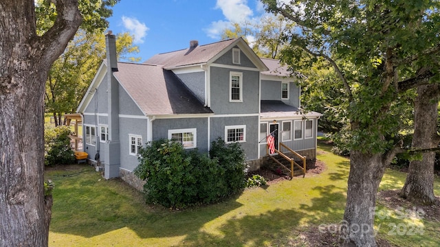 rear view of house with a yard