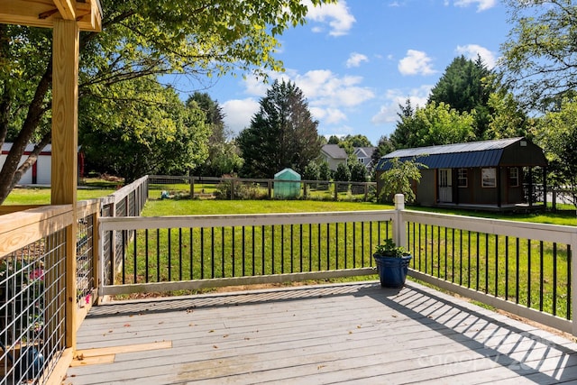 deck featuring a shed and a lawn