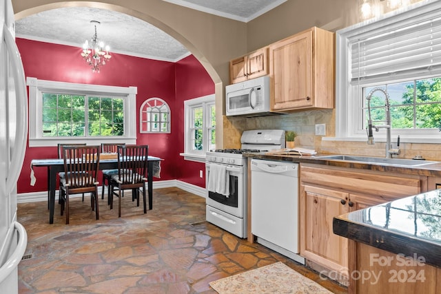 kitchen featuring an inviting chandelier, tasteful backsplash, sink, a textured ceiling, and white appliances