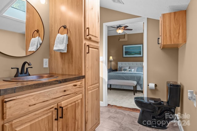 bathroom featuring tile patterned flooring, ceiling fan, and vanity