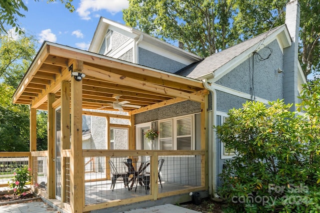 exterior space featuring ceiling fan and a wooden deck