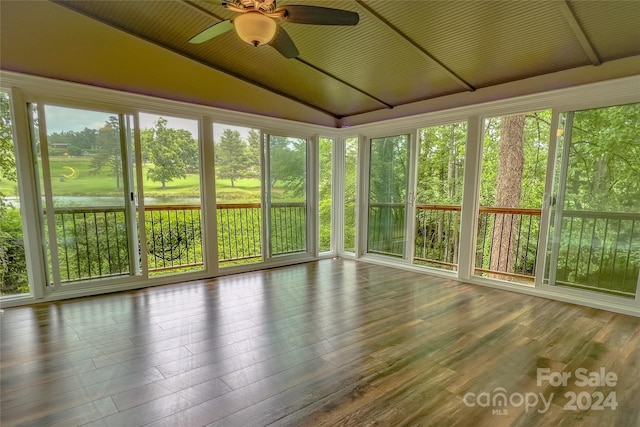 unfurnished sunroom with ceiling fan and lofted ceiling