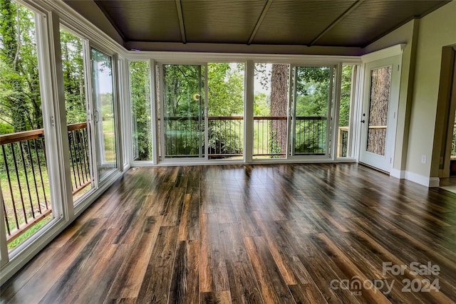 unfurnished sunroom with vaulted ceiling and plenty of natural light