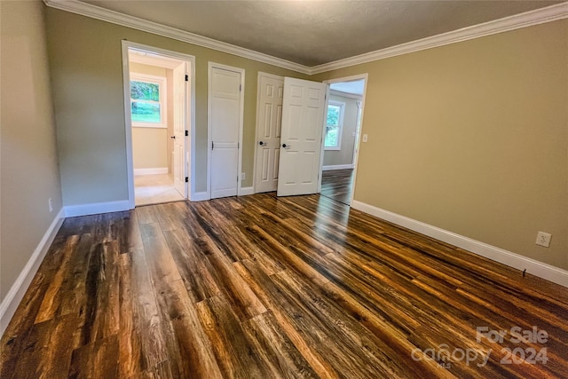 unfurnished bedroom with crown molding and hardwood / wood-style flooring