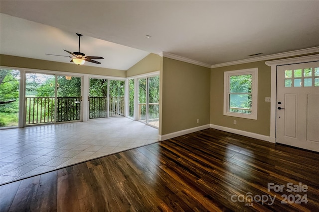 tiled foyer entrance featuring ceiling fan, vaulted ceiling, and crown molding