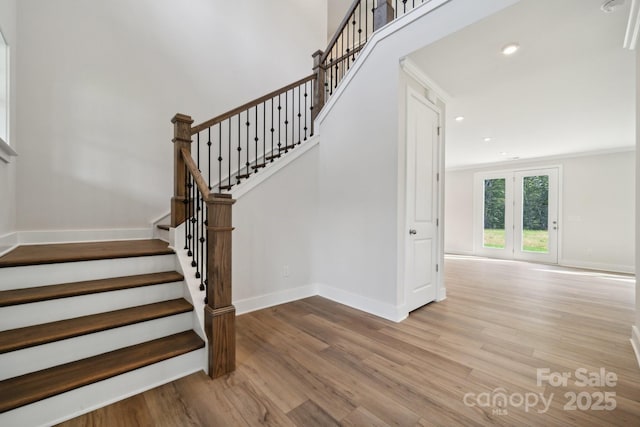 stairway featuring hardwood / wood-style floors and crown molding