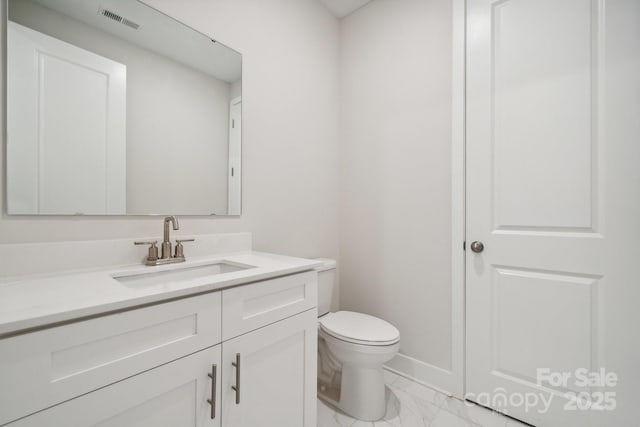 bathroom featuring vanity and toilet