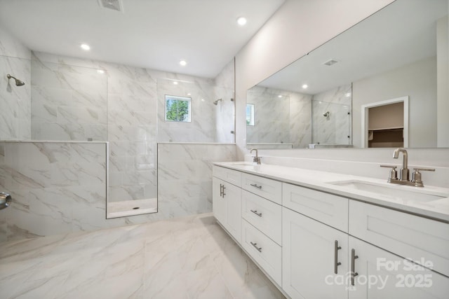 bathroom featuring vanity and tiled shower