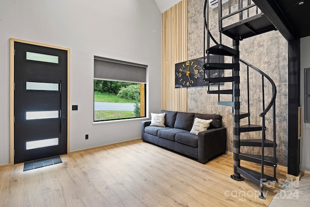 living room featuring a high ceiling and hardwood / wood-style floors