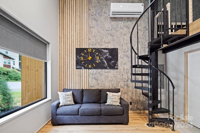 living room featuring a wall mounted AC and hardwood / wood-style flooring