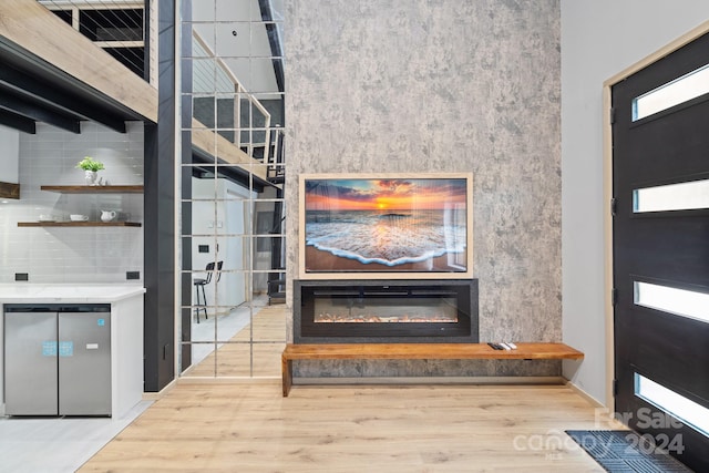 details with stainless steel dishwasher, hardwood / wood-style flooring, and tasteful backsplash