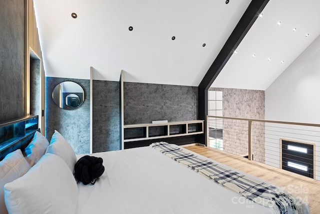 bedroom featuring beam ceiling, high vaulted ceiling, and hardwood / wood-style floors