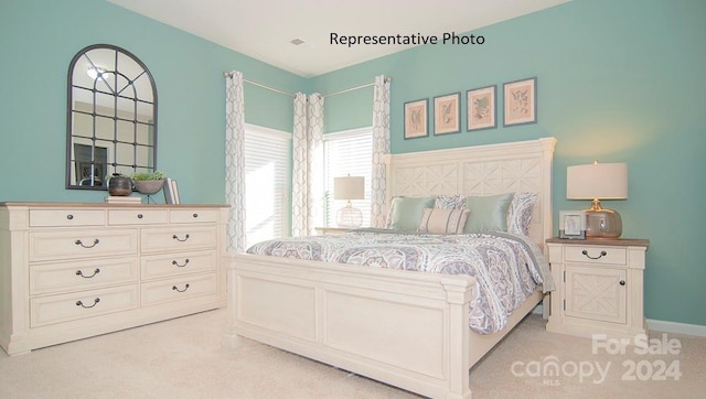 bedroom with light colored carpet