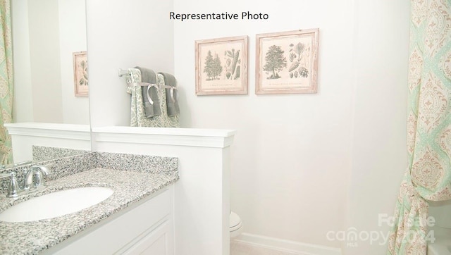 bathroom featuring toilet and vanity