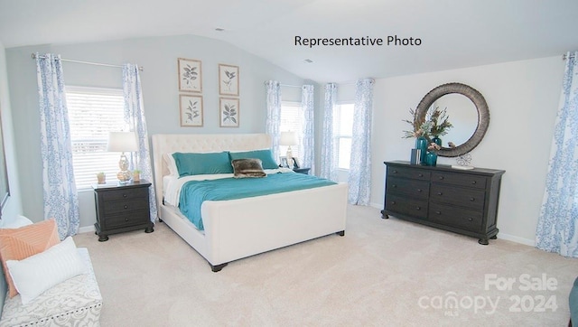 carpeted bedroom featuring multiple windows and vaulted ceiling