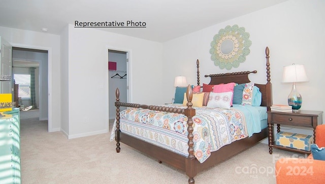 bedroom featuring a spacious closet and carpet floors