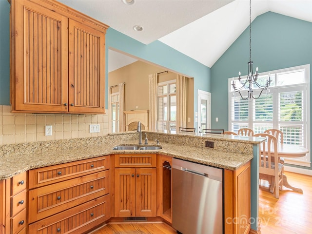 kitchen featuring light hardwood / wood-style flooring, light stone counters, kitchen peninsula, sink, and stainless steel dishwasher