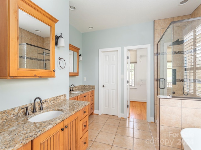 bathroom with walk in shower, vanity, and hardwood / wood-style floors