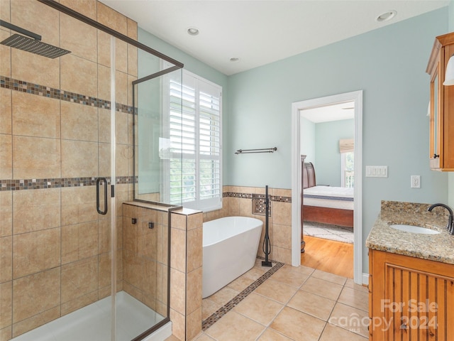 bathroom with vanity, hardwood / wood-style floors, and independent shower and bath