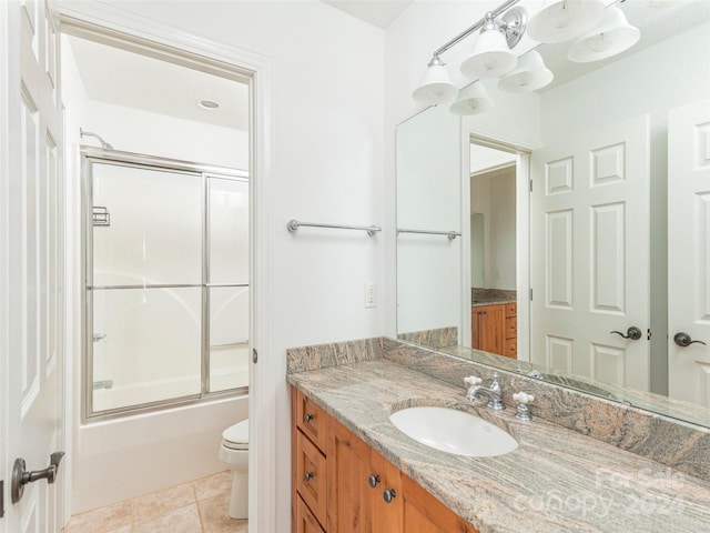 full bathroom featuring vanity, toilet, tile patterned floors, and enclosed tub / shower combo