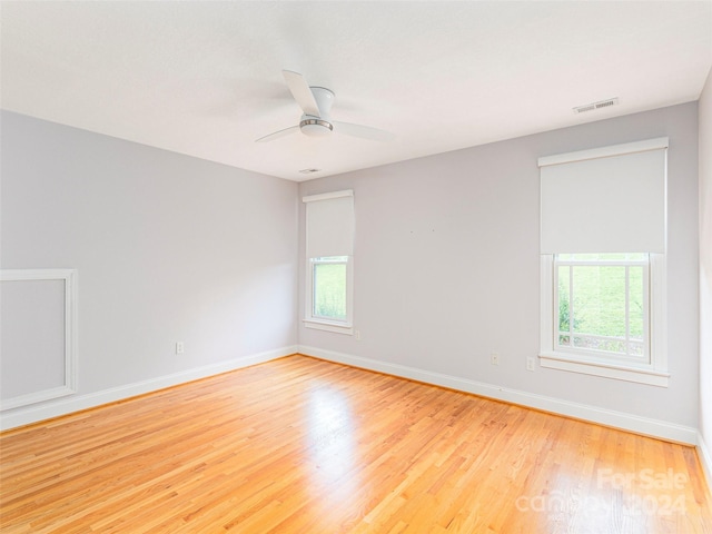 spare room featuring ceiling fan and light hardwood / wood-style floors