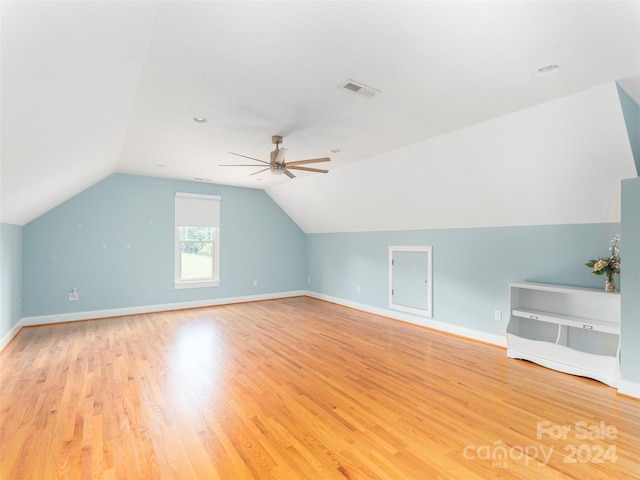 additional living space featuring vaulted ceiling, ceiling fan, and light hardwood / wood-style floors