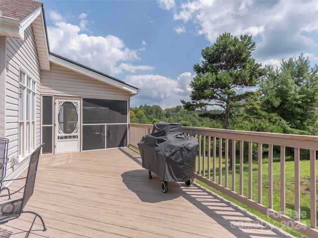 wooden terrace with area for grilling and a sunroom