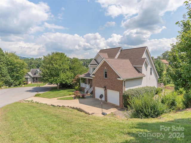 view of home's exterior featuring a garage and a lawn