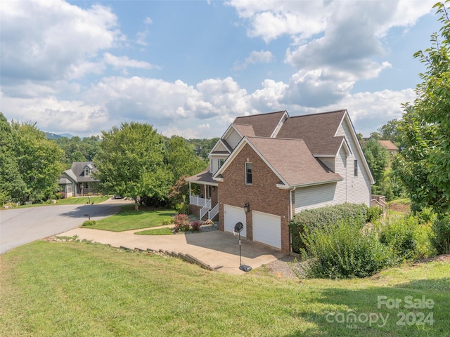 view of side of home featuring concrete driveway, an attached garage, brick siding, a shingled roof, and a yard