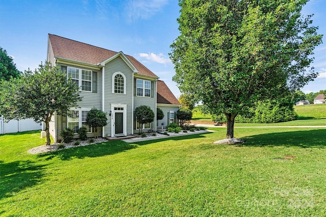 back of house featuring a lawn