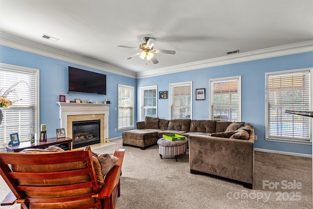 living room featuring carpet floors, visible vents, ornamental molding, and a fireplace with flush hearth