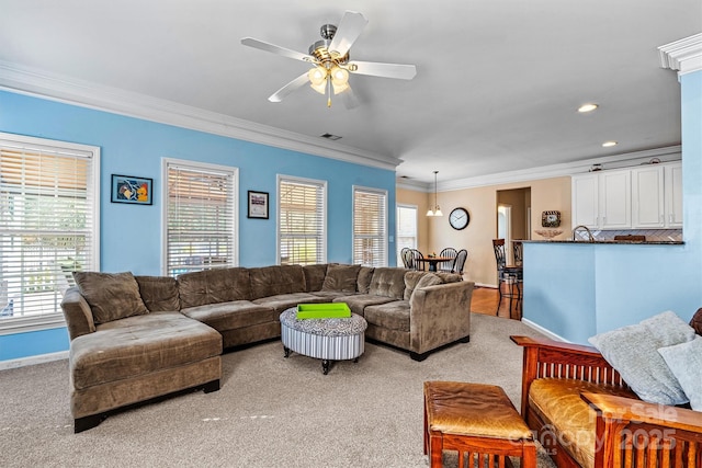 living room featuring light carpet, ceiling fan, ornamental molding, and baseboards