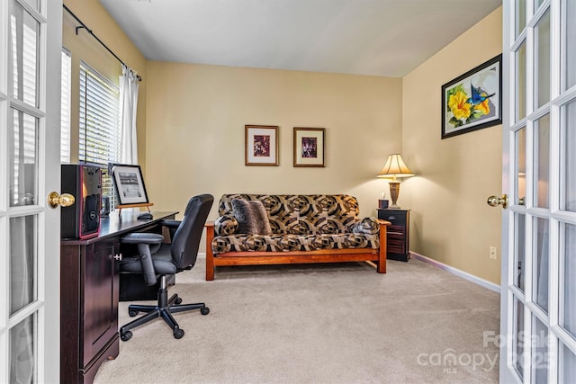 carpeted home office featuring french doors and baseboards