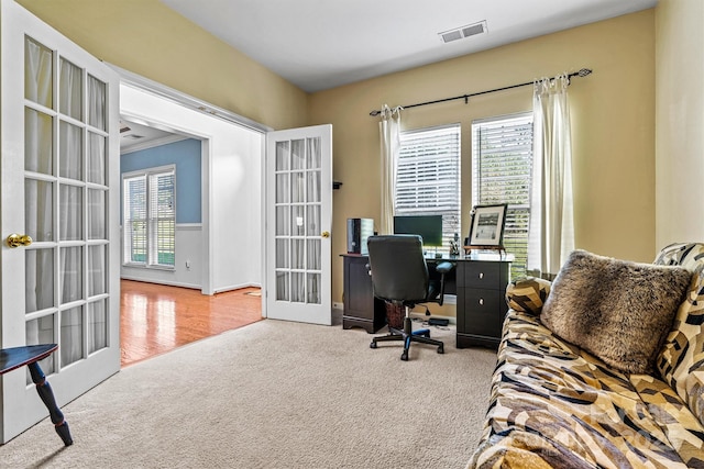 carpeted office space with visible vents, ornamental molding, and french doors