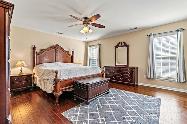 bedroom with visible vents, multiple windows, and hardwood / wood-style flooring