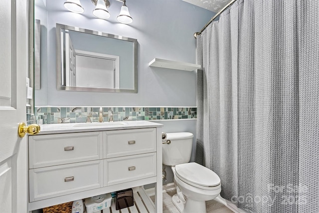 full bathroom featuring toilet, a wainscoted wall, tile walls, and vanity