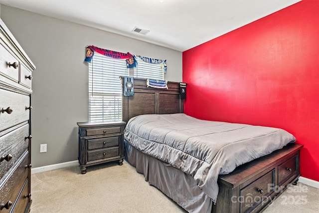 bedroom featuring light colored carpet, visible vents, and baseboards