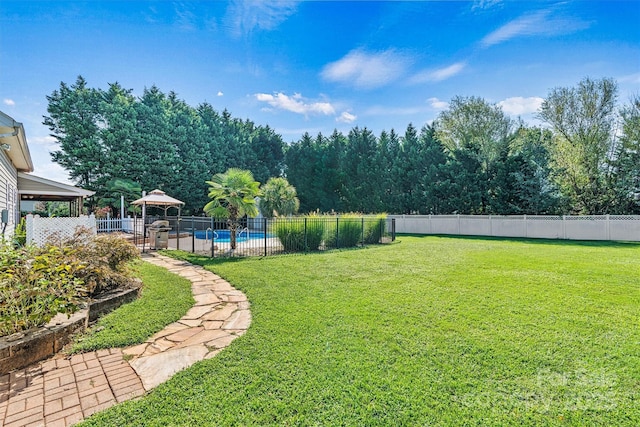 view of yard with a fenced in pool and a fenced backyard